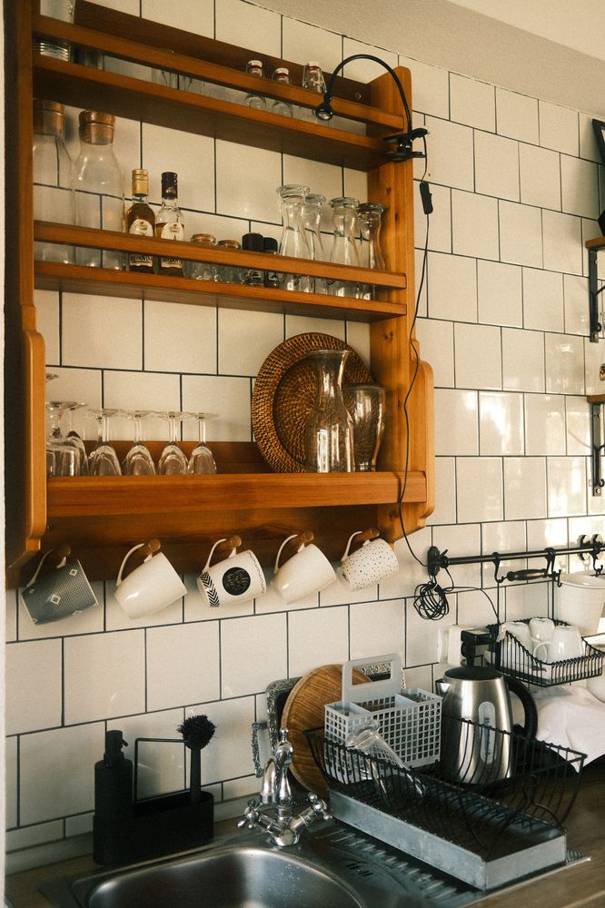 Timber open shelving detail against a white metro-tile splashback